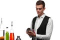 A bartender cleaning a shaker for beverages, isolated on a white background. Cocktail ingredients on a bar counter.