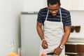 African man preparing healthy food at home in kitchen Royalty Free Stock Photo