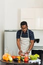 African man preparing healthy food at home in kitchen Royalty Free Stock Photo