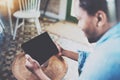 Attractive bearded African man using laptop while relaxing on armchair in modern office.Concept of young business people Royalty Free Stock Photo