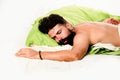 Attractive bearded guy holding in hands pillow in bed. Slumber man. Wake up Sleepy. Need some rest. Royalty Free Stock Photo