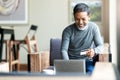 Attractive bearded hipster asian father or Hispanic old man using Laptop and credit card payment shopping online with customer Royalty Free Stock Photo