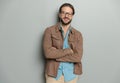 attractive bearded man with glasses folding arms and smiling Royalty Free Stock Photo