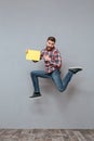 Attractive bearded man holding copyspace blank jumping