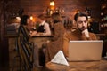 Attractive bearded man working on his laptop in a coffee shop Royalty Free Stock Photo