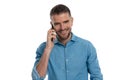 Attractive bearded middle aged guy having a conversation on the phone