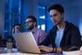 Attractive bearded programmer typing on the laptop