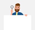 Attractive bearded young man showing/holding magnifying glass and blank/empty poster, paper or sheet in hand. Search, find.