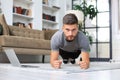 Attractive beared man doing plank exercise at home. Fitness is the key to health Royalty Free Stock Photo