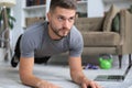 Attractive beared man doing plank exercise at home. Fitness is the key to health Royalty Free Stock Photo