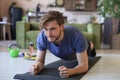 Attractive beared man doing plank exercise at home during quarantine. Fitness is the key to health Royalty Free Stock Photo