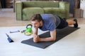 Attractive beared man doing plank exercise at home during quarantine. Fitness is the key to health Royalty Free Stock Photo