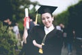 Attractive Beautiful Asian Graduated woman in cap and gown smile