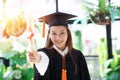 Attractive Beautiful Asian Graduated woman in cap and gown smile with certificated
