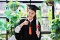 Attractive Beautiful Asian Graduated woman in cap and gown smile with certificated