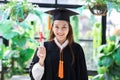 Attractive Beautiful Asian Graduated woman in cap and gown smile with certificated feeling so proud