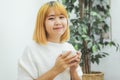 Attractive beautiful asian woman enjoying warm coffee in the kitchen at her home. Royalty Free Stock Photo