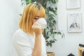 Attractive beautiful asian woman enjoying warm coffee in the kitchen at her home. Royalty Free Stock Photo