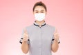 Attractive Beautiful Asian woman maid wearing face mask smile and thumbs up hand sign feeling so happiness and confident