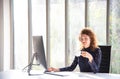 Attractive beautiful and confident business woman working with computer and drinking coffee in the modern office or home Royalty Free Stock Photo