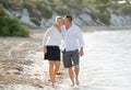 Attractive beautiful couple in love walking on the beach kissing in romantic summer holidays Royalty Free Stock Photo