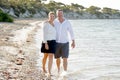 Attractive beautiful couple in love walking on the beach in romantic summer holidays Royalty Free Stock Photo