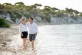 Attractive beautiful couple in love walking on the beach in romantic summer holidays Royalty Free Stock Photo