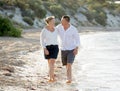 Attractive beautiful couple in love walking on the beach in romantic summer holidays Royalty Free Stock Photo