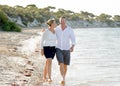 Attractive beautiful couple in love walking on the beach in romantic summer holidays Royalty Free Stock Photo