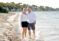 Attractive beautiful couple in love walking on the beach in romantic summer holidays Royalty Free Stock Photo