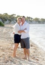 Attractive beautiful couple in love walking on the beach in romantic summer holidays Royalty Free Stock Photo