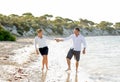 Attractive beautiful couple in love walking on the beach in romantic summer holidays Royalty Free Stock Photo