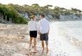 Attractive beautiful couple in love walking on the beach in romantic summer holidays Royalty Free Stock Photo