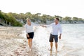 Attractive beautiful couple in love walking on the beach in romantic summer holidays Royalty Free Stock Photo