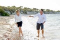 Attractive beautiful couple in love walking on the beach in romantic summer holidays Royalty Free Stock Photo