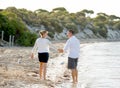 Attractive beautiful couple in love walking on the beach in romantic summer holidays Royalty Free Stock Photo