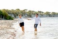 Attractive beautiful couple in love walking on the beach in romantic summer holidays Royalty Free Stock Photo