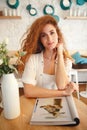 Attractive beautiful redhead young lady sitting in cafe Royalty Free Stock Photo