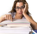 Attractive and beautiful tired student girl leaning on school books pile tired and exhausted after studying preparing exam looking Royalty Free Stock Photo