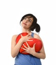 Attractive and beautiful woman smiling happy feeling in love holding red heart shape pillow Royalty Free Stock Photo