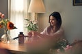 A woman arranging a vase with beautiful flowers to decorate her living room Royalty Free Stock Photo