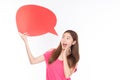 Attractive beautiful young asian woman smile and excited holding empty speech bubble on white background Royalty Free Stock Photo