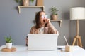 Attractive beautiful young Caucasian female feel tired and overworked, woman in glasses work remotely from home or sitting at Royalty Free Stock Photo
