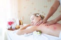 Attractive beautiful young woman relax lying on massage bed, Masseur doing scrub massage on woman body in spa salon. Spa aroma Royalty Free Stock Photo