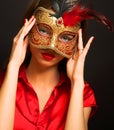 Attractive beautiful young woman wearing red cold carnival mask Royalty Free Stock Photo