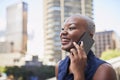 An attractive Black businesswoman laughs on a call on the office balcony Royalty Free Stock Photo