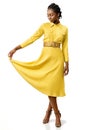 Attractive black girl in stylish yellow dress.