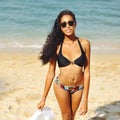 Attractive black haired woman on a beach