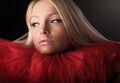 Attractive blond beauty in red theatrical jabot