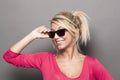 Attractive blond lady with raybans smiling